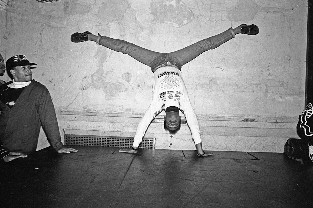 Dancer wearing jeans and a sweater upside down, voguing at the nightclub Mars in 1988 in New York City.