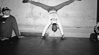 Dancer wearing jeans and a sweater upside down, voguing at the nightclub Mars in 1988 in New York City.