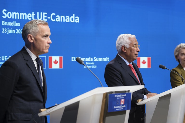 Canadian Prime Minister Mark Carney, EU Council President Antonio Costa, and European Commission President Ursula von der Leyen stand at podiums