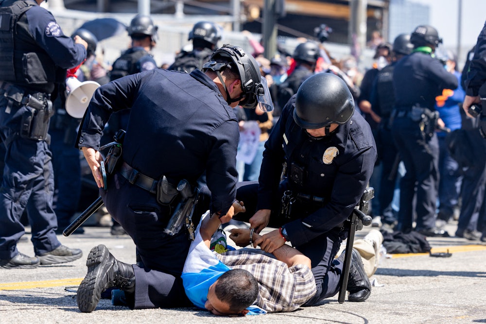 LAPD officers arrested a protester during an anti-ICE protest in downtown Los Angeles on June 8.