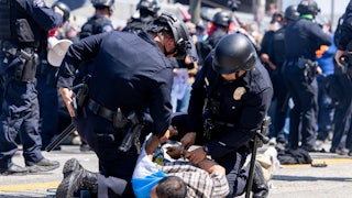 LAPD officers arrested a protester during an anti-ICE protest in downtown Los Angeles on June 8.