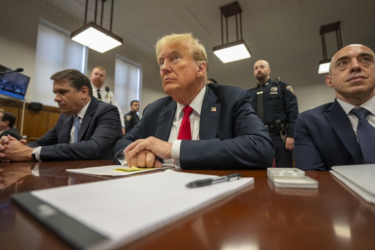 Donald Trump sits between his lawyers Todd Blanche and Emil Love
