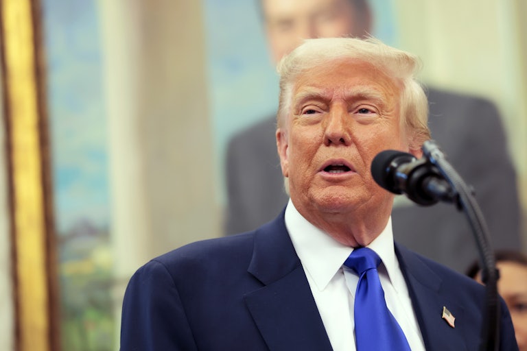 Donald Trump speaking at a lectern