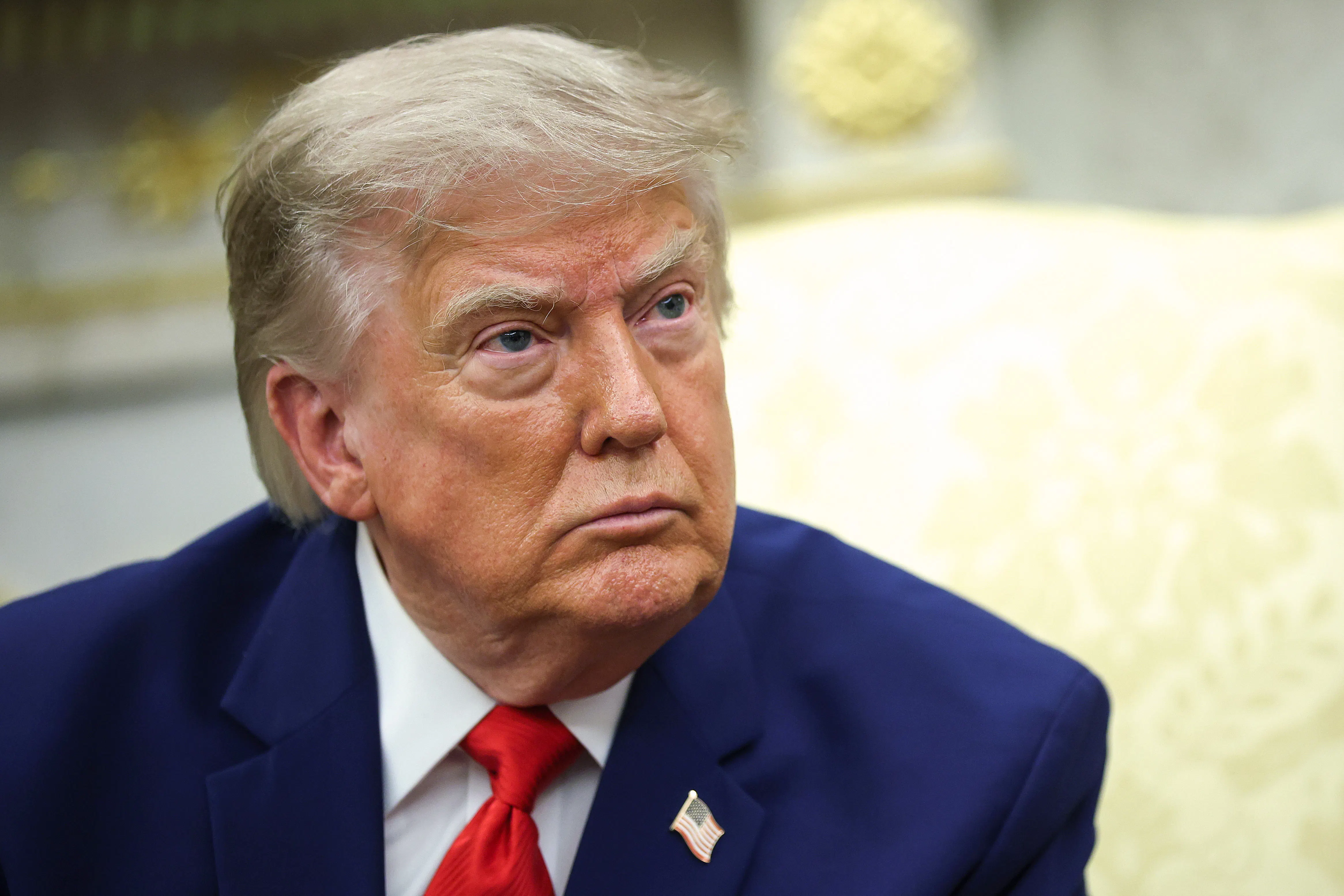 Donald Trump sits in the Oval Office
