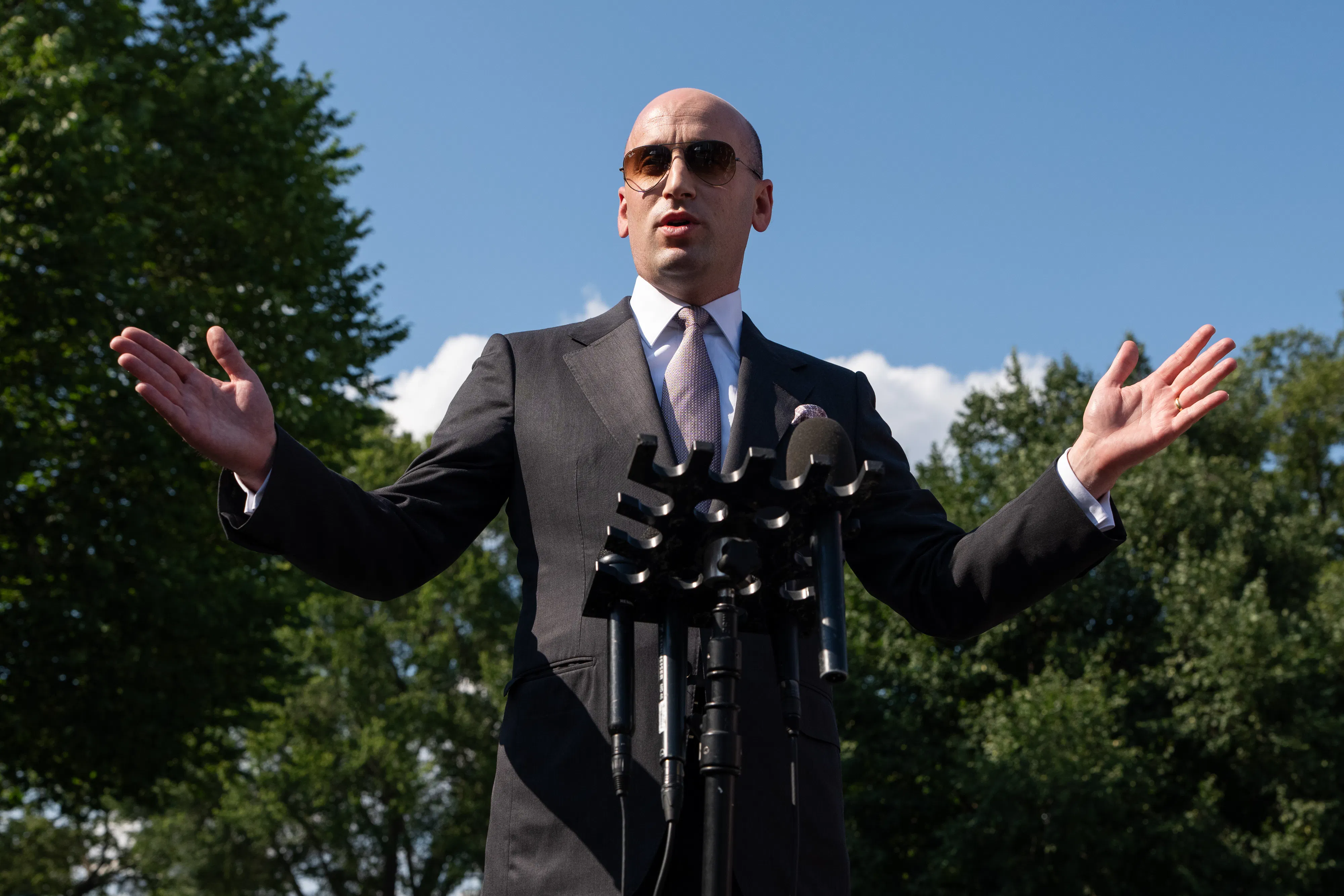 Stephen Miller speaking at a microphone