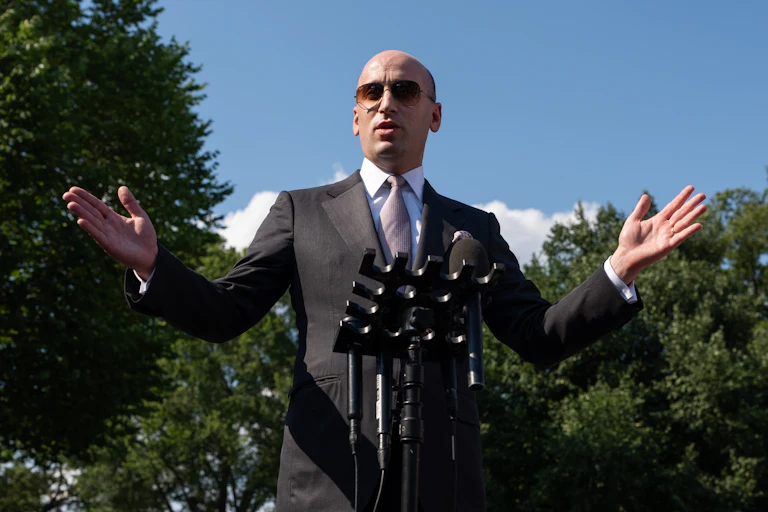 Stephen Miller speaking at a microphone