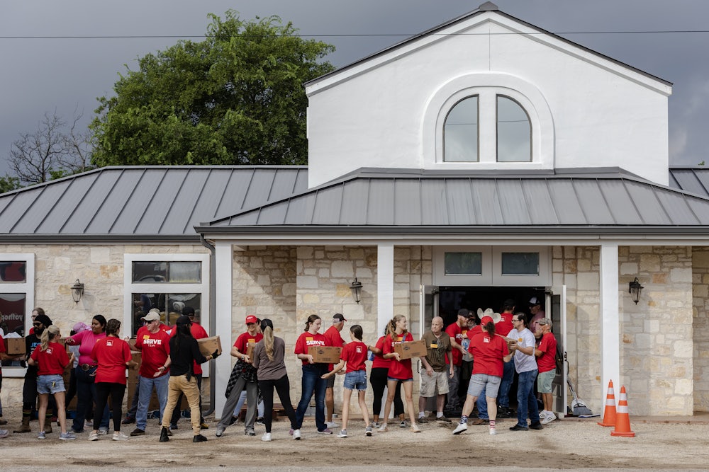Volunteers unload a semi-truck full of supplies delivered by Convoy of Hope to Gateway Kerrville Church for those in need and who were affected by the deadly flash flooding on July 7, 2025 in Ingram, Texas.