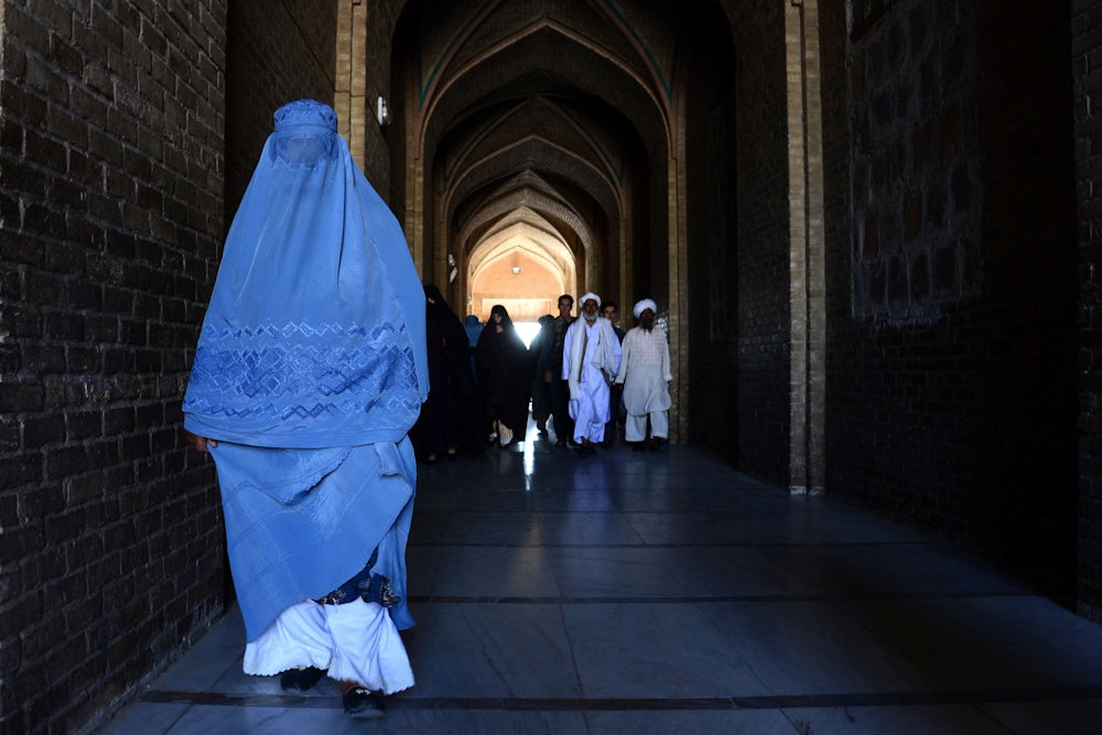 A burqa-clad Afghan woman on her way to offer prayers at the Jami mosque in Herat.