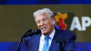 Donald Trump speaks into a microphone during the APEC summit in South Korea