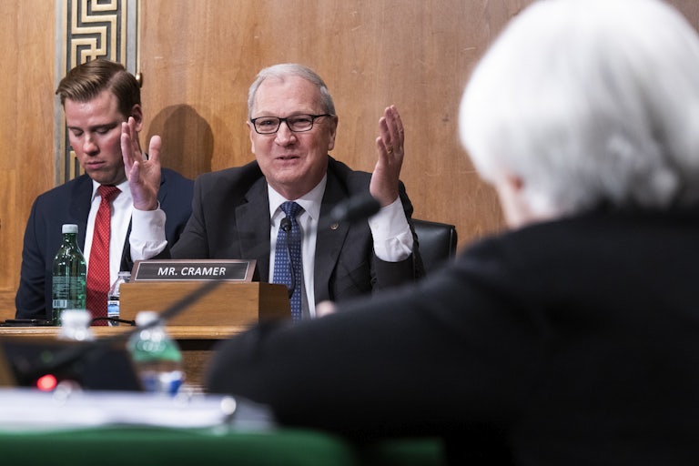Kevin Cramer holds his hands up while speaking.