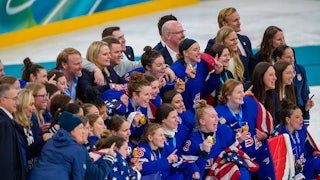 U.S. women's hocky team celebrate their victory at the Olympics, holding up their gold medals.