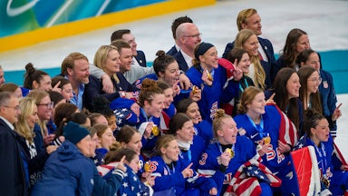 U.S. women's hocky team celebrate their victory at the Olympics, holding up their gold medals.