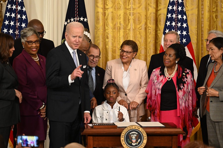 Gianna Floyd, daughter of George Floyd, holds a pen during a signing ceremony at the White House