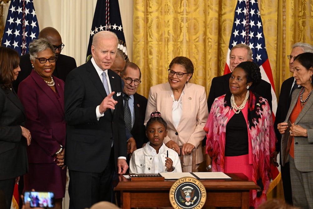 Gianna Floyd, daughter of George Floyd, holds a pen during a signing ceremony at the White House