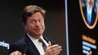 U.S. Attorney for the Southern District of New York Jay Clayton gestures and speaks while sitting on stage during an event