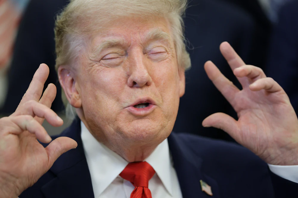 Donald Trump raises hands in gesture with eyes closed