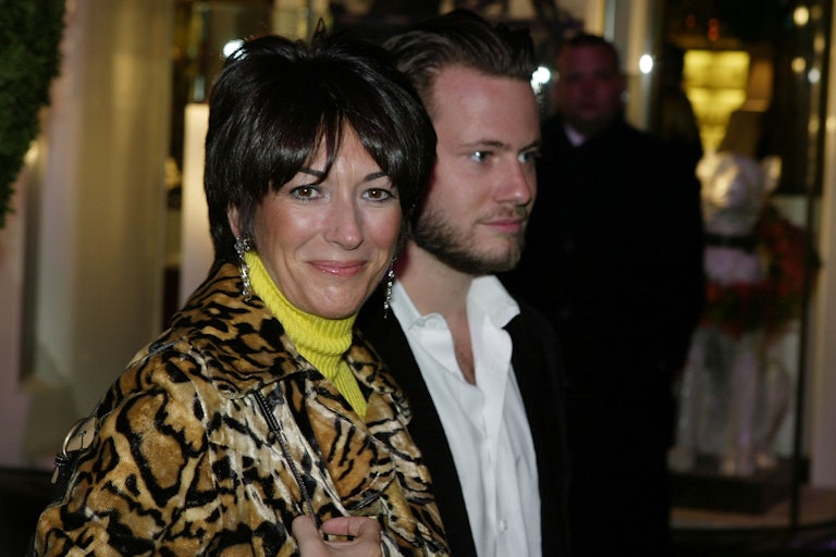 Ghislaine Maxwell walks with a man by her side.