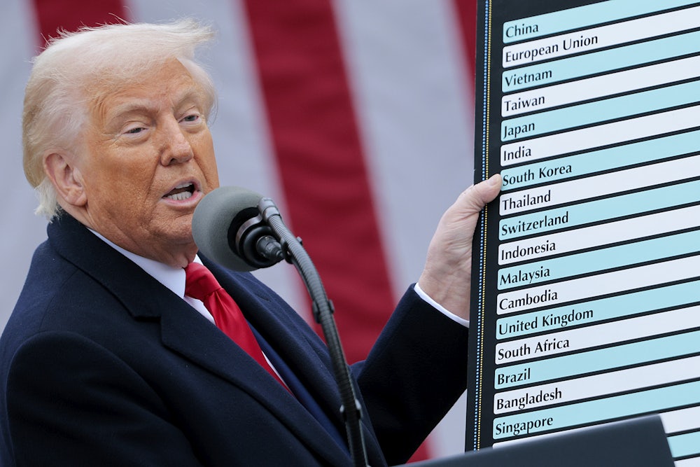 Donald Trump holds up a chart while speaking during a “Make America Wealthy Again” tariff announcement event in the Rose Garden at the White House.