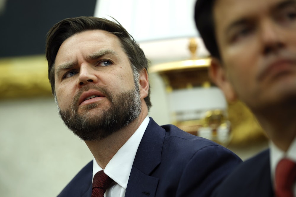 JD Vance cranes his neck to look at something.