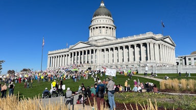 No Kings protesters gather on the lawn in front of Utah’s Capitol.