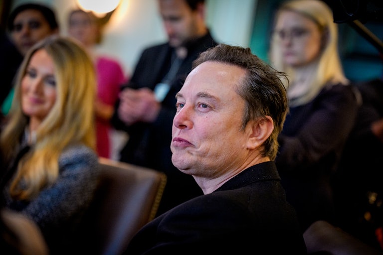 Elon Musk purses his lips while sitting in Donald Trump's Cabinet meeting