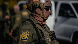 A masked federal immigration officer