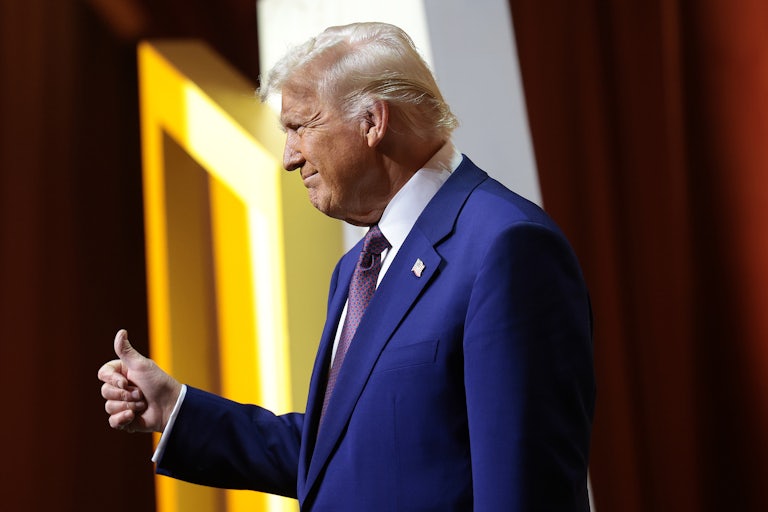 Donald Trump gives a thumbs-up on stage at the Republican Governors' Association meeting