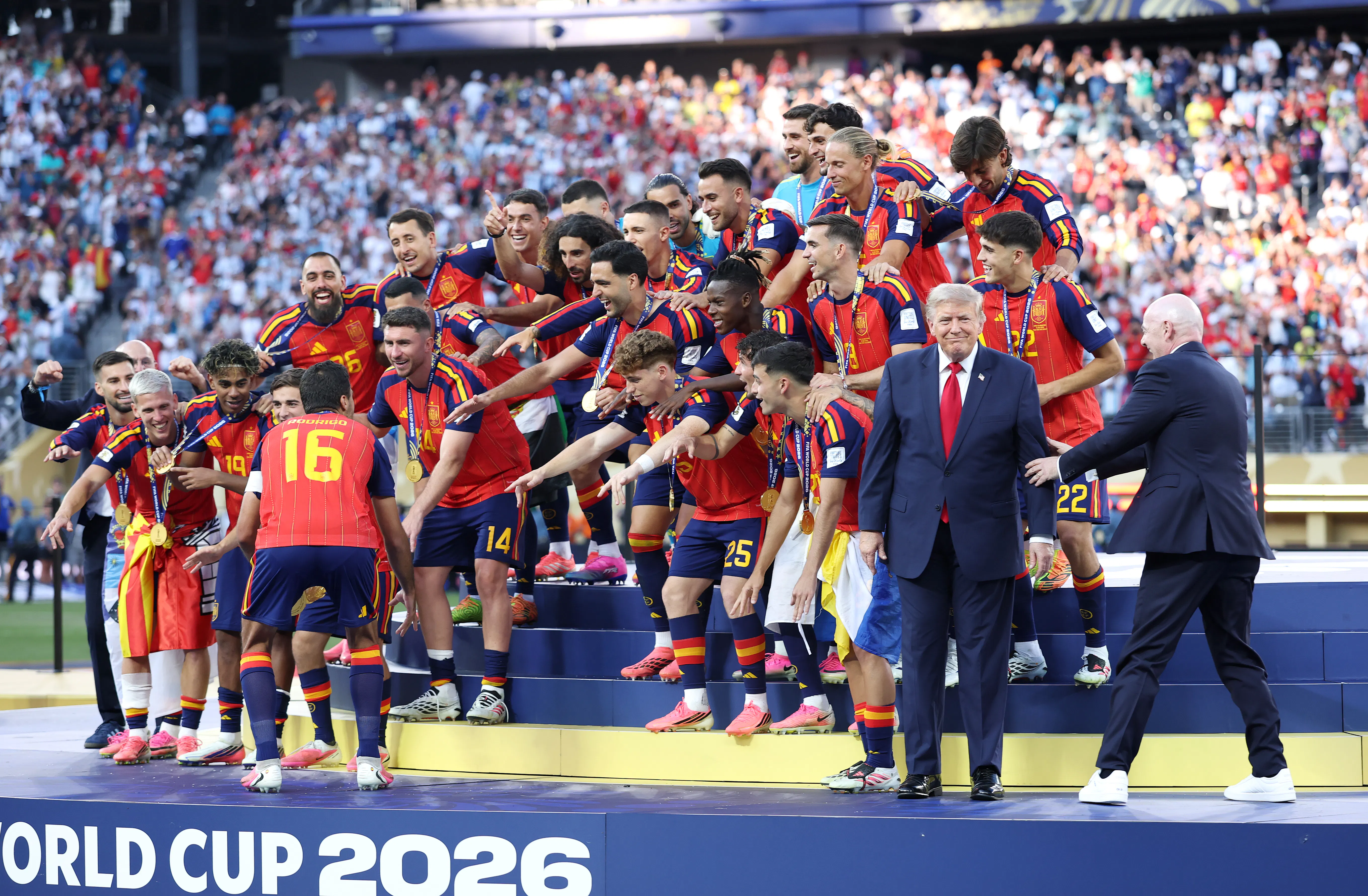 Spain celebrates winning the World Cup as FIFA President Gianni Infantino tries to coax President Trump off the stage.