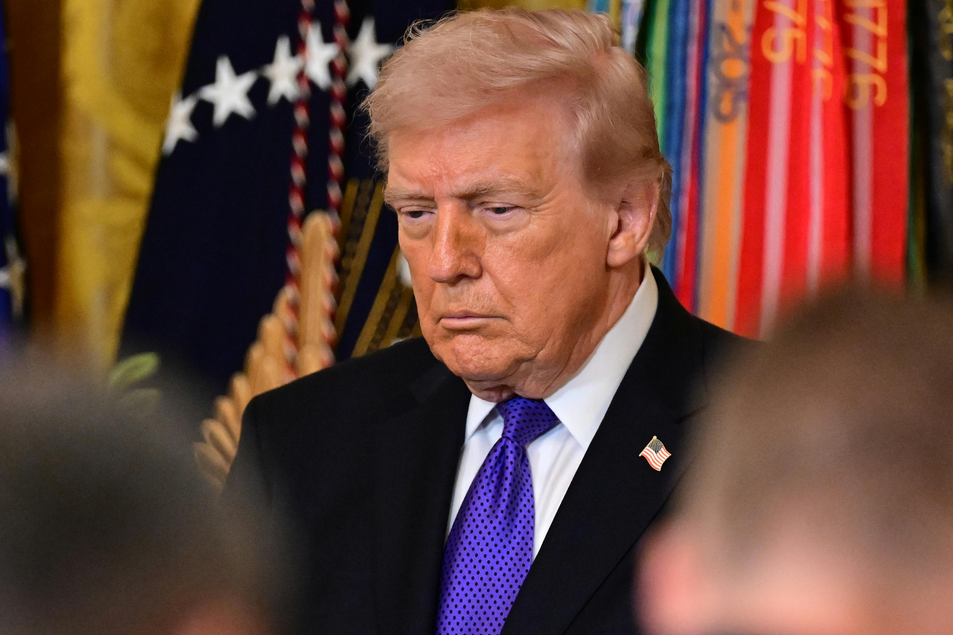 Donald Trump stands during a Medal of Honor ceremony at the White House