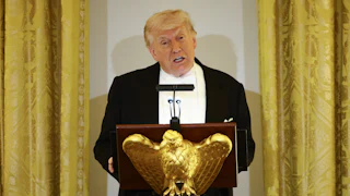Donald Trump speaks at a podium