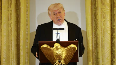 Donald Trump speaks at a podium