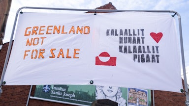 A sign says, "Greenland is not for sale" in English and and "Greenland is for Greenlanders" in Greenlandic