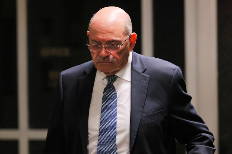 Allen Weisselberg looks down as he walks