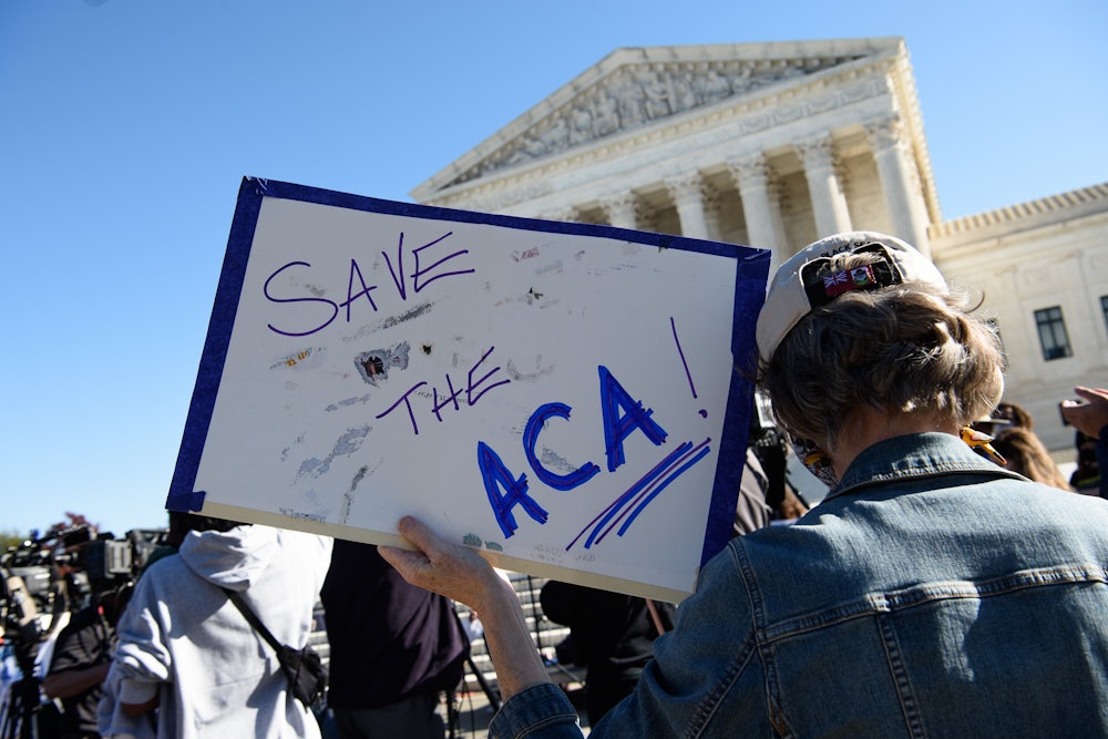 A demonstrator holds a sign in front of the US Supreme Court in support of the Affordable Care Act.