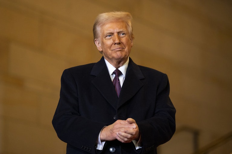 Donald Trump clasps his hands together in the Capitol