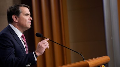 Deputy Attorney General Todd Blanche gestures while speaking at a podium