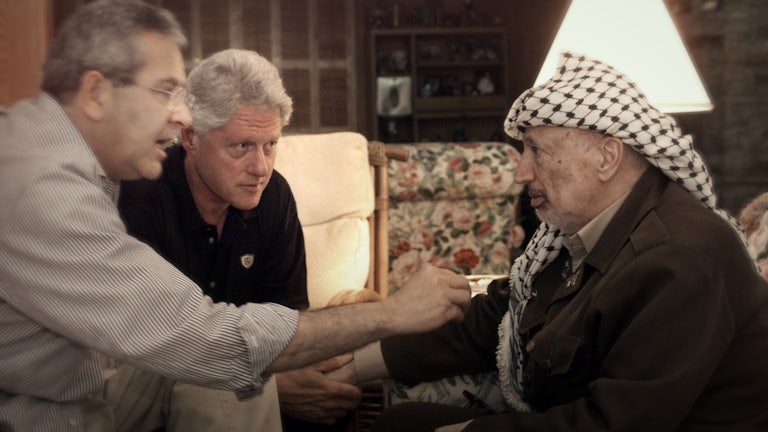 President Bill Clinton and Gamal Hamal speak closely with Yasser Arafat, touching his arm.