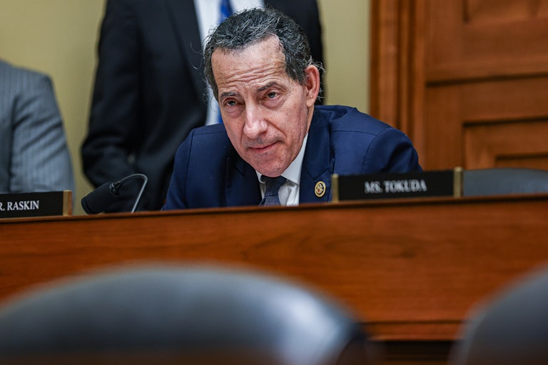 Jamie Raskin leans over a desk