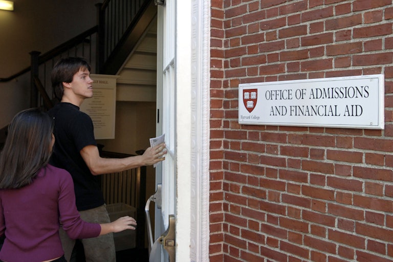 Students enter the Admissions Building on the campus of Harvard University.