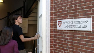 Students enter the Admissions Building on the campus of Harvard University.
