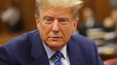 Donald Trump looks into the camera, looking a bit haggard (and old).