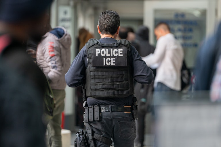 ICE agent walking away (only his back his shown)