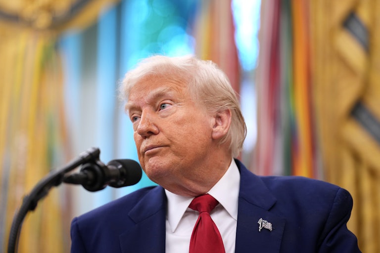 Donald Trump stands in front of a mic in the White House.