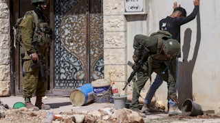 Israeli soldiers check a Palestinian man at the entrance of Tulkarem camp, in the occupied West Bank, during a military operation on July 6, 2025.