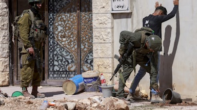 Israeli soldiers check a Palestinian man at the entrance of Tulkarem camp, in the occupied West Bank, during a military operation on July 6, 2025.