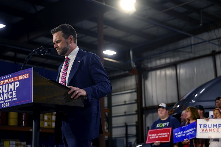J.D. Vance looks down while on stage during a Donald Trump campaign event