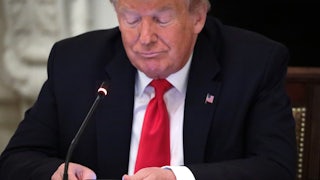 Donald Trump scrolls on his phone.