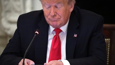 Donald Trump scrolls on his phone.