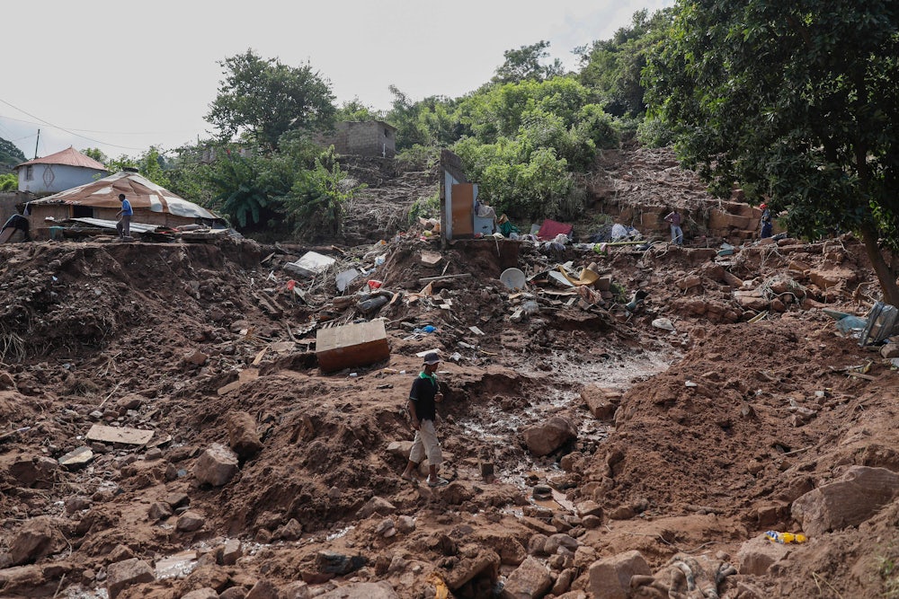 A man walks on rubble.