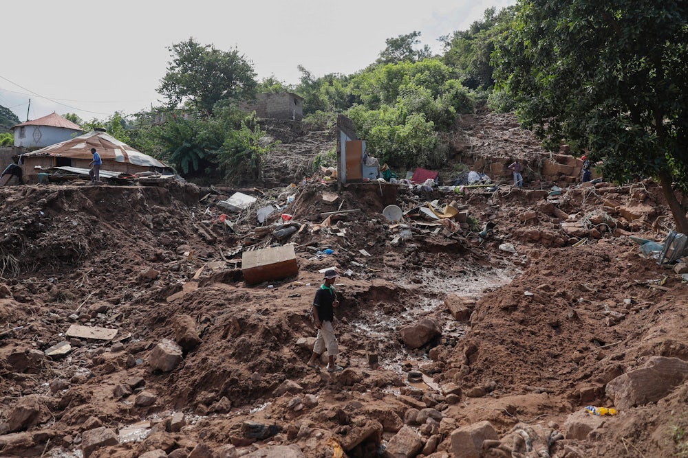 A man walks on rubble.
